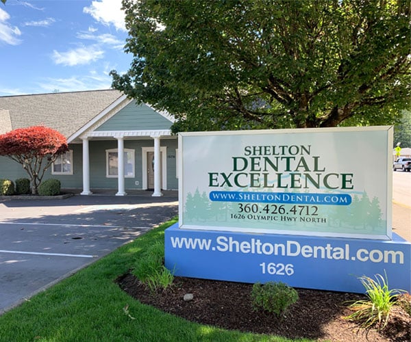 Shelton Dental Excellence exterior storefront with signage, landscaping, and building entrance.